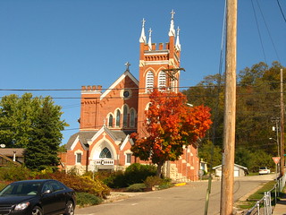 A red brick church, and a steep street that runs alongside the church.