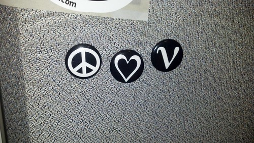 Buttons with peace symbol, heart, and Greek letter nu