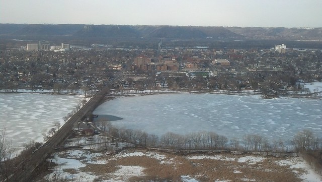 A bird's-eye view of Lake Winona from the viewpoint at Garvin Heights. The lake is frozen but starting to melt.