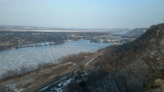 A bird's-eye view of Lake Winona, showing the valley to the south. The lake is frozen but starting to melt.